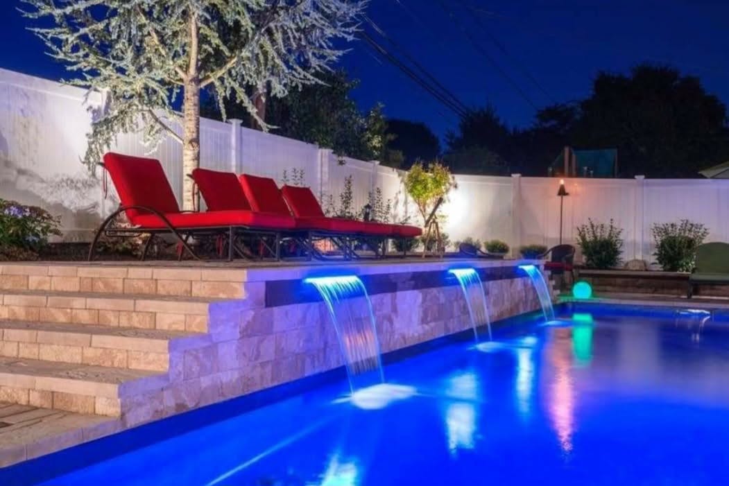 Pool with illuminated cascading water features