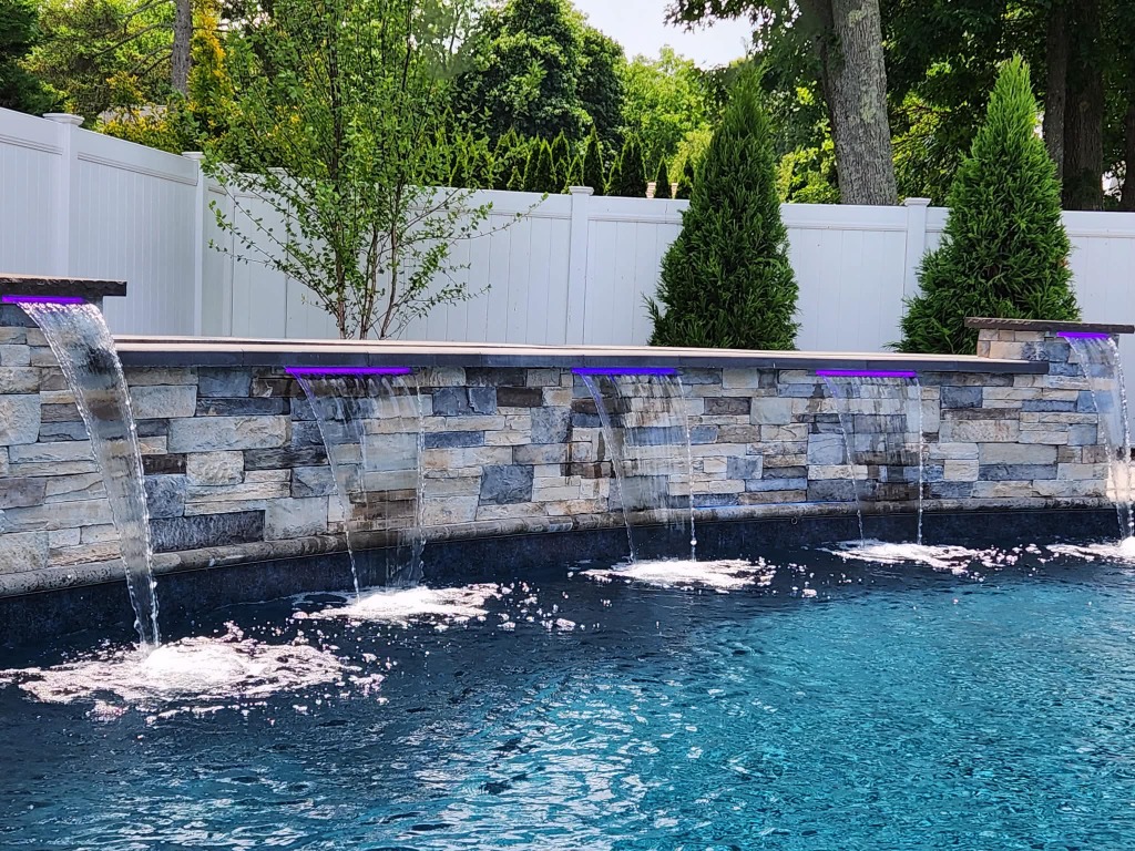 Stone pool wall with multiple water features